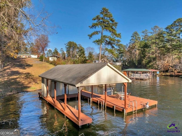 view of dock with boat lift and a water view