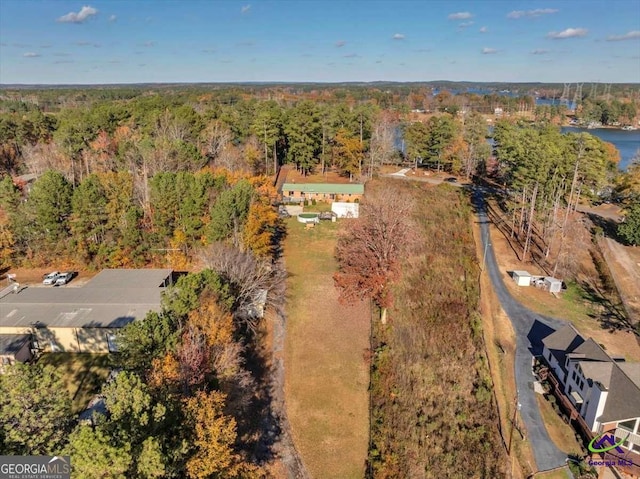 birds eye view of property featuring a view of trees