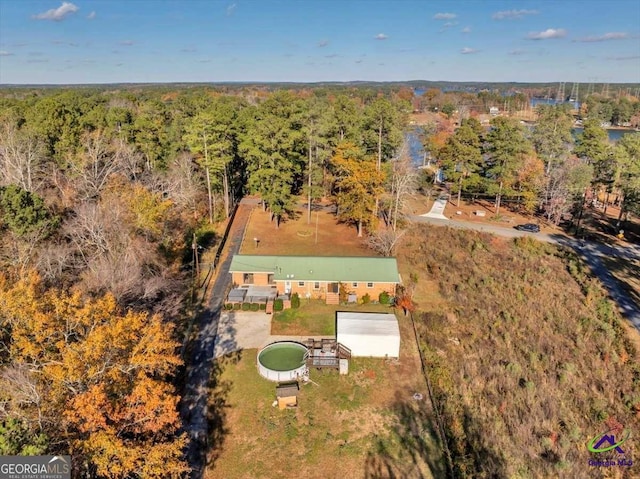 drone / aerial view featuring a forest view