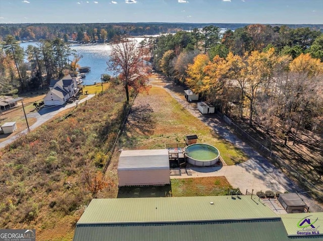 bird's eye view featuring a forest view and a water view