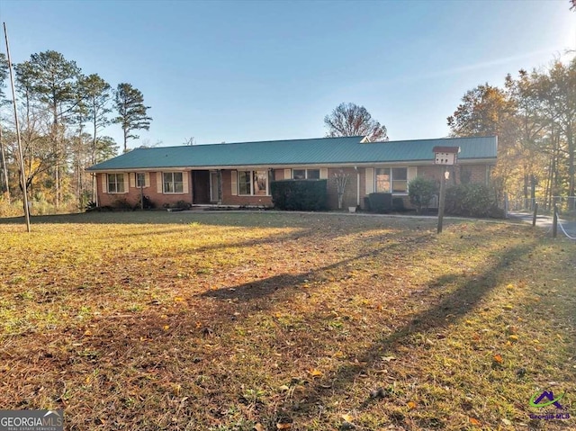 ranch-style house with brick siding and a front lawn