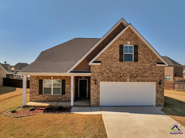 view of front of property featuring brick siding, covered porch, concrete driveway, and fence