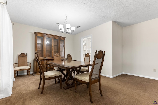 dining area with baseboards, light colored carpet, visible vents, and a chandelier