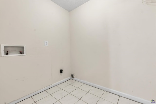 laundry room featuring washer hookup, laundry area, light tile patterned floors, and baseboards