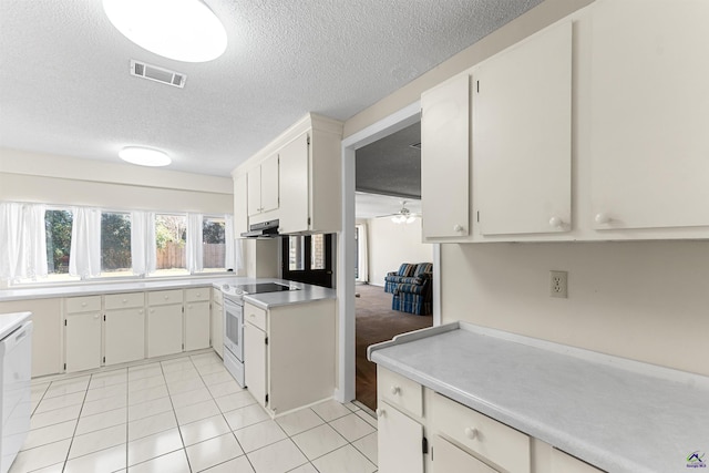 kitchen with visible vents, light countertops, light tile patterned flooring, white appliances, and a textured ceiling