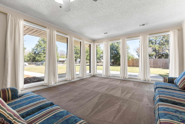 sunroom featuring visible vents and ceiling fan