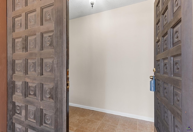 interior space with baseboards and a textured ceiling