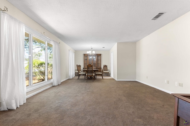 sitting room featuring visible vents, baseboards, carpet flooring, an inviting chandelier, and a textured ceiling