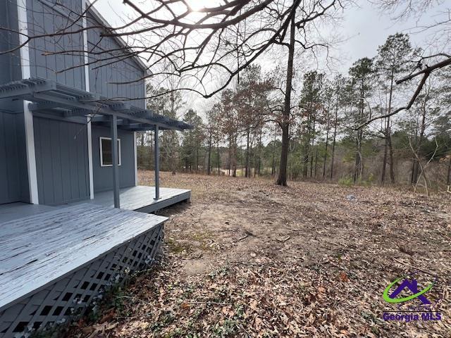 view of yard featuring a deck and a pergola