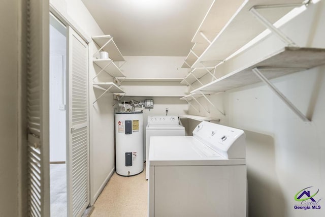 clothes washing area featuring laundry area, separate washer and dryer, and electric water heater