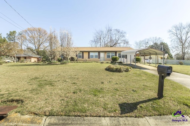 single story home with a detached carport, a front lawn, and driveway