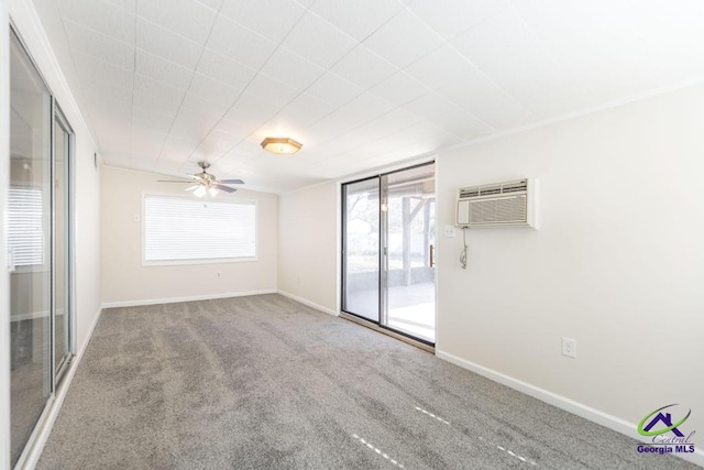 empty room with a ceiling fan, carpet, baseboards, and a wall mounted AC