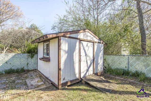 view of shed with a fenced backyard