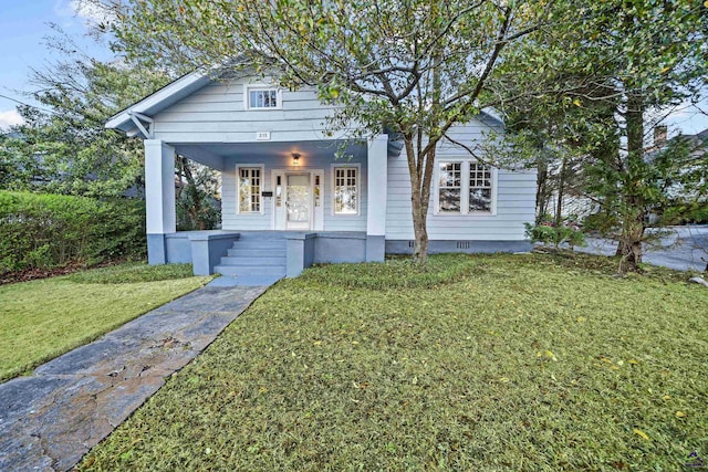 view of front facade featuring crawl space, covered porch, and a front lawn