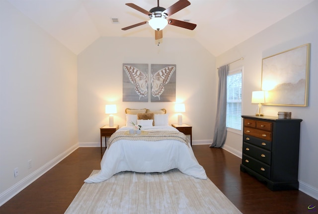 bedroom featuring visible vents, baseboards, lofted ceiling, and wood finished floors