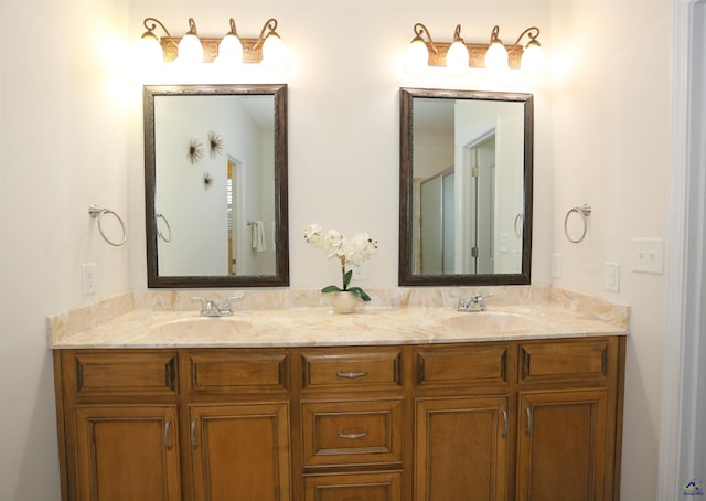 full bathroom with double vanity and a sink