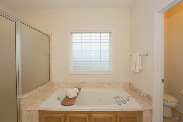 full bathroom with a shower stall, toilet, and a garden tub