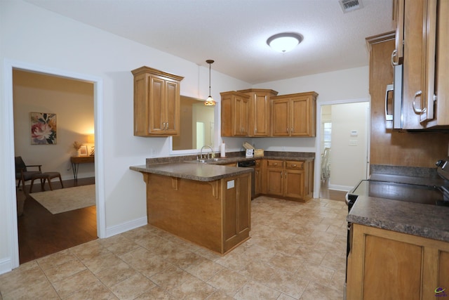 kitchen featuring brown cabinets, a peninsula, and electric range oven