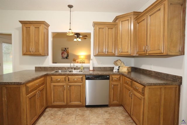 kitchen with stainless steel dishwasher, dark countertops, brown cabinets, and a sink