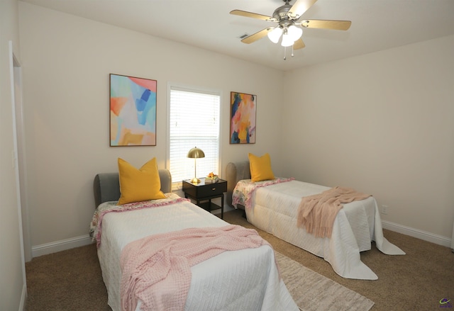 carpeted bedroom featuring ceiling fan and baseboards