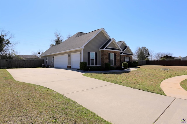 view of front of house with driveway, a front lawn, fence, an attached garage, and brick siding