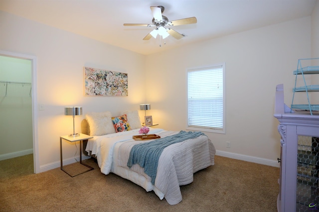 carpeted bedroom featuring baseboards and a ceiling fan