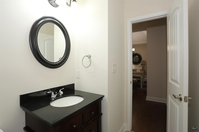 bathroom with wood finished floors and vanity