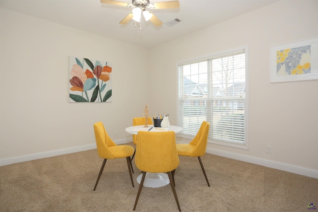 dining room featuring visible vents, baseboards, carpet, and a ceiling fan