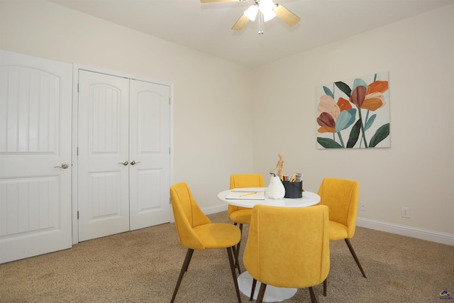 dining space featuring carpet flooring, ceiling fan, and baseboards