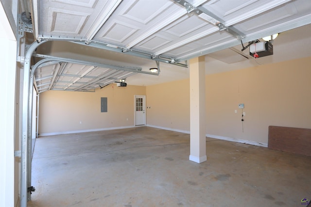 garage featuring electric panel, baseboards, and a garage door opener