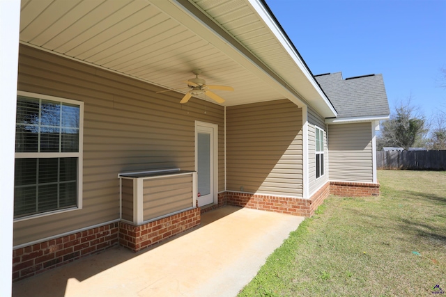 exterior space with a patio, fence, roof with shingles, a yard, and ceiling fan