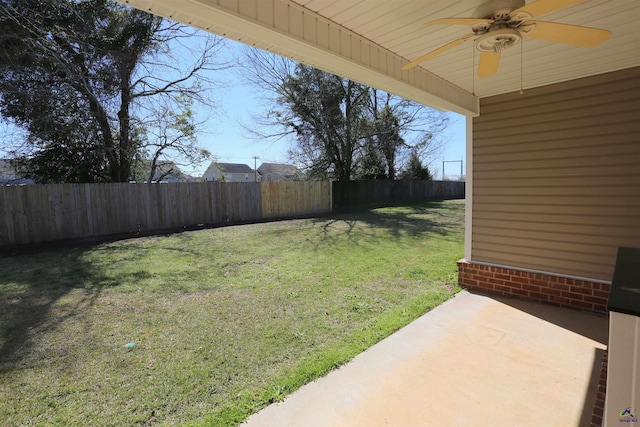 view of yard with a fenced backyard, ceiling fan, and a patio area