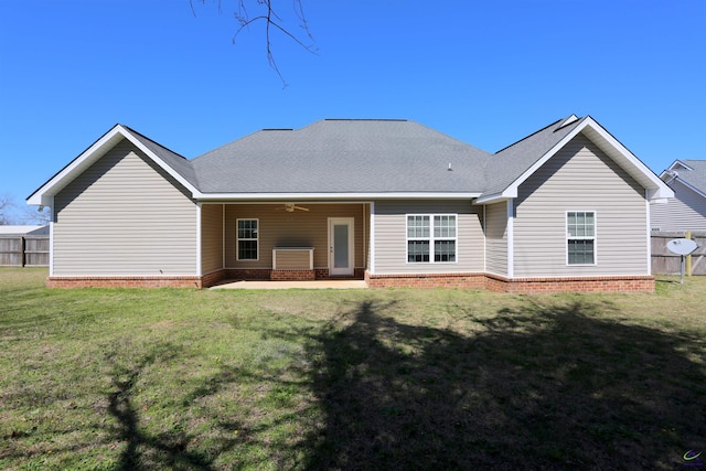 back of property featuring a ceiling fan, a patio, fence, a yard, and roof with shingles