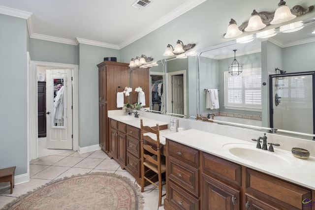 bathroom with tile patterned flooring, a spacious closet, visible vents, and a sink