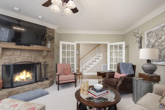 carpeted living room with a ceiling fan, stairway, a fireplace, and ornamental molding