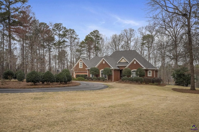 craftsman house with brick siding and a front yard