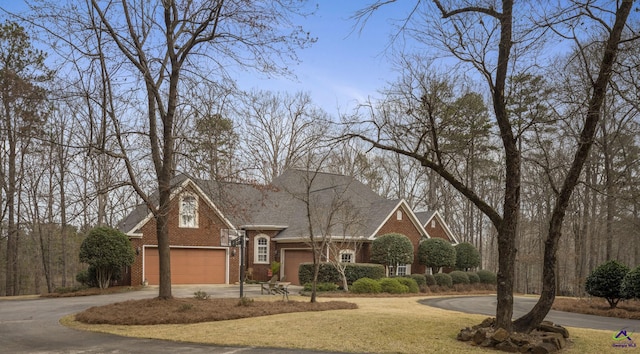 view of front of property featuring concrete driveway, an attached garage, and brick siding