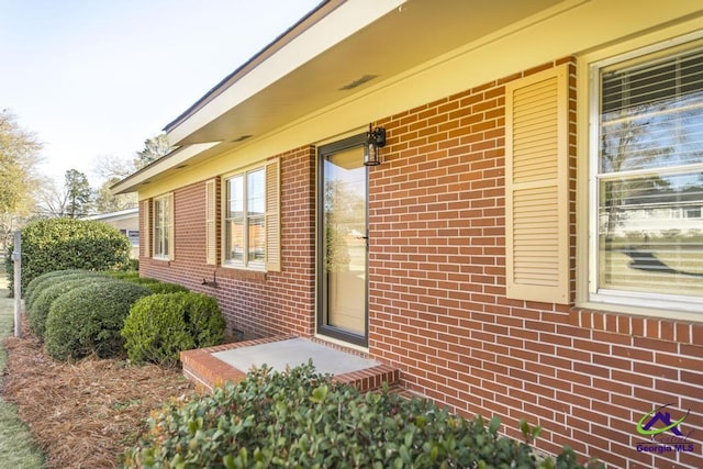 property entrance with brick siding