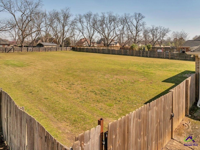 view of yard with a fenced backyard