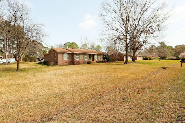 view of front of house featuring a front yard and brick siding