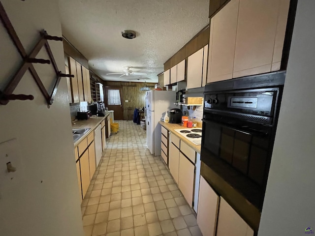 kitchen with a ceiling fan, a sink, a textured ceiling, white appliances, and light countertops