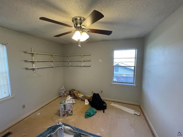 spare room featuring visible vents, baseboards, and a textured ceiling