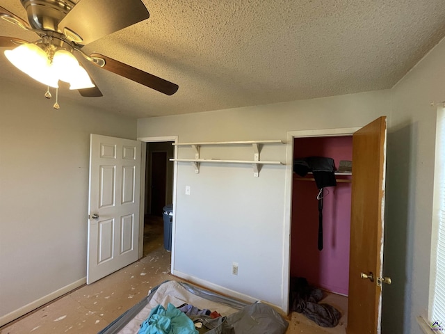 bedroom featuring a closet, ceiling fan, a textured ceiling, and baseboards