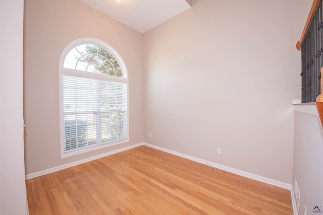 empty room with light wood-type flooring, plenty of natural light, and baseboards