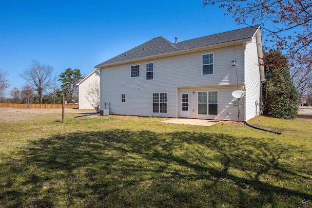 back of property with a patio, a lawn, central AC, and fence