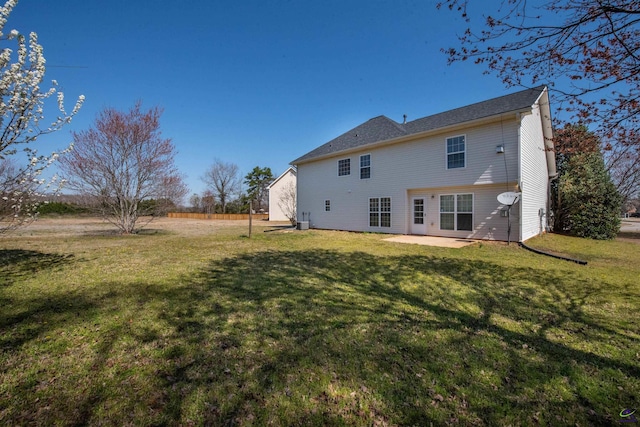 back of property with a patio and a yard