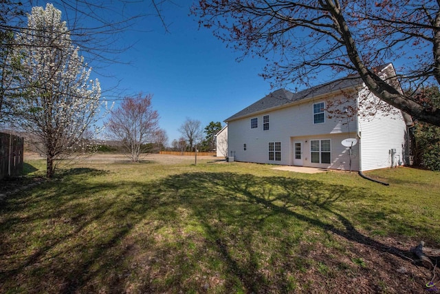 back of house featuring a patio, a yard, and fence