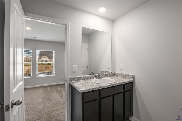 bathroom with vanity and baseboards