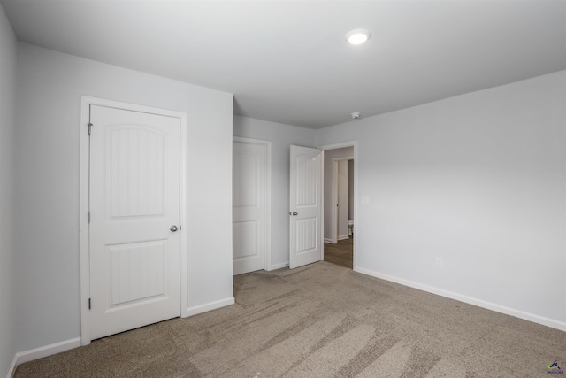 unfurnished bedroom with baseboards and carpet floors