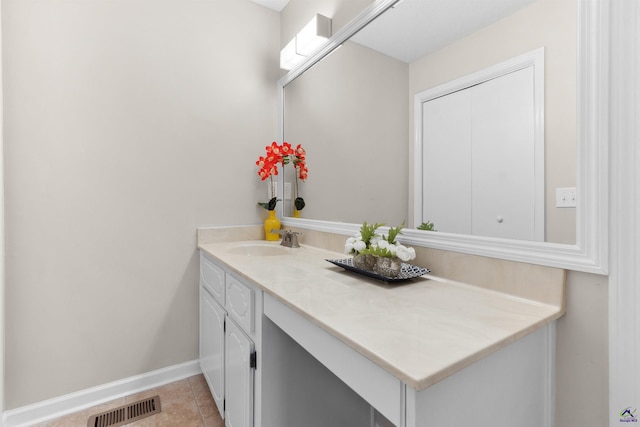 bathroom with tile patterned flooring, visible vents, vanity, and baseboards